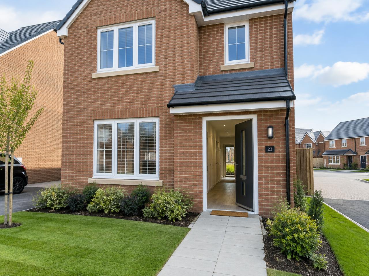 Newly completed brick new-build home with the front door open